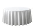 Round table covered with a white tablecloth on a white background
