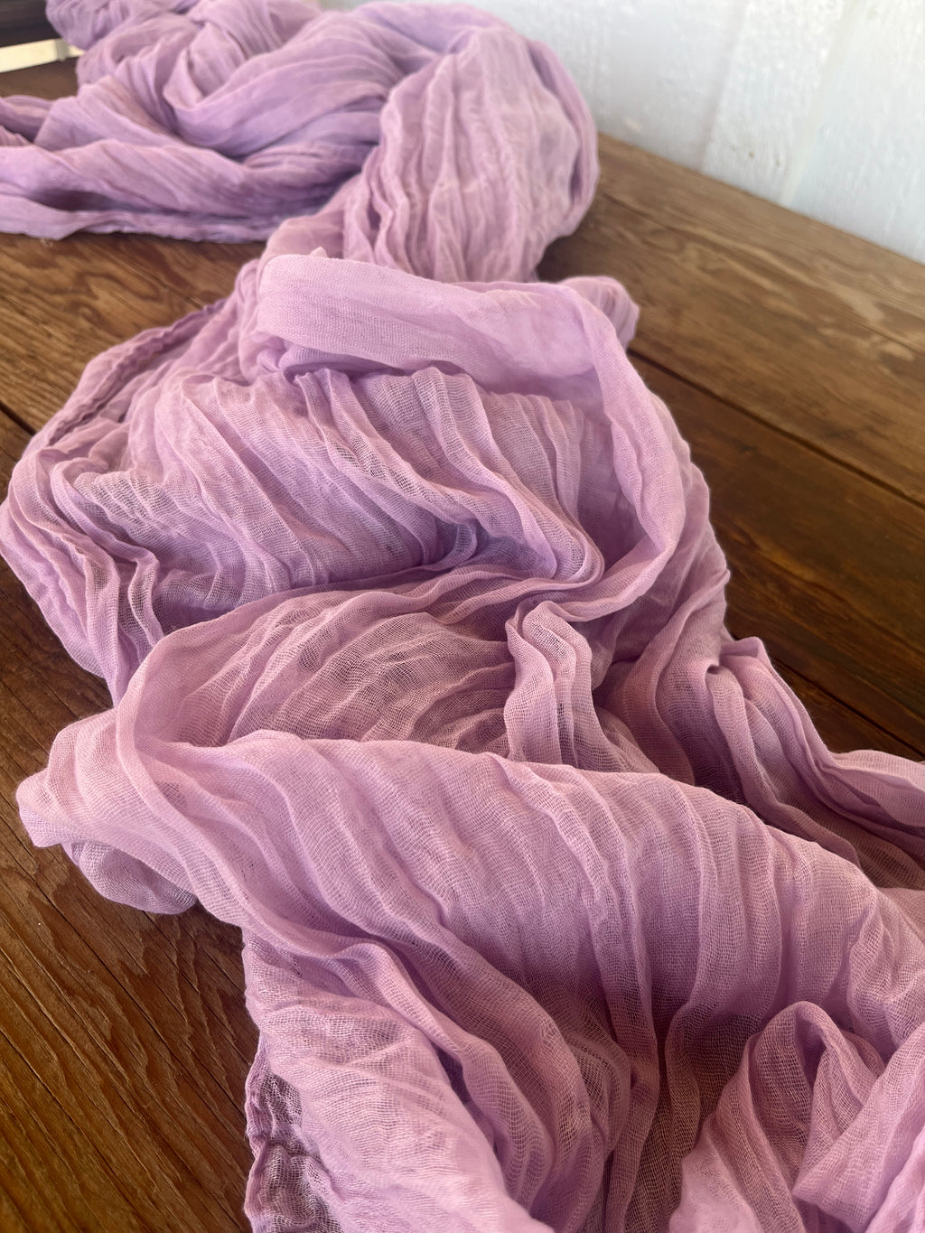 Purple fabric on a wooden surface