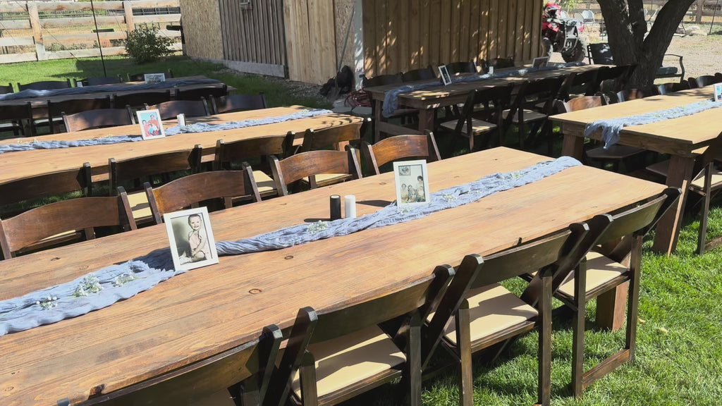video of tables and chairs set up with table runners and photos on the table