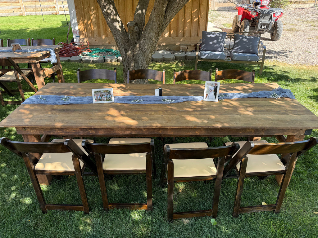 Outdoor setting with wooden dining table and chairs on a grassy area